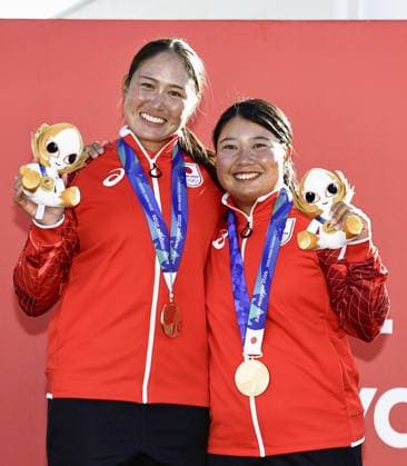 Aichi-Nagoya Asian Games: Sailing Japanese sailors Misaki Tanaka (R) and Sera Nagamatsu pose during the medal ceremony held at Kaiyoh Yacht Harbor in Gamagori in Aichi Prefecture, central Japan, on Oct. 2, 2026, a day after winning gold in the Aichi-Nagoya Asian Games women s skiff. A14AA0005629828P