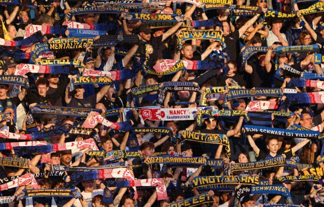 October 2, 2026, Soccer, Men s, Friendly Match, 2026–2027 Season, 1 FC Saarbrücken vs. AS Nancy Lorraine, 1 FC Saarbrücken fans hold up their scarves and sing the team song together; Saarbrücken, Ludwigsparkstadion, Saarland, Germany Copyright: xFabianxKleerx