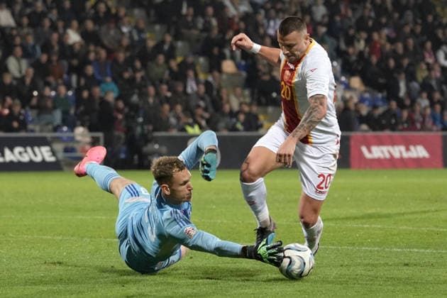 Goalkeeper Rihards Matrevics (23) of Latvia In action against Milutin Osmajic (20) of Montenegro during UEFA Nations League Group C2 football game between Latvia and Montenegro in Riga, Latvia, Fri, Oct. 2, 2026. Riga Latvia Copyright: xRomanxKoksarovx RKV09935.JPG