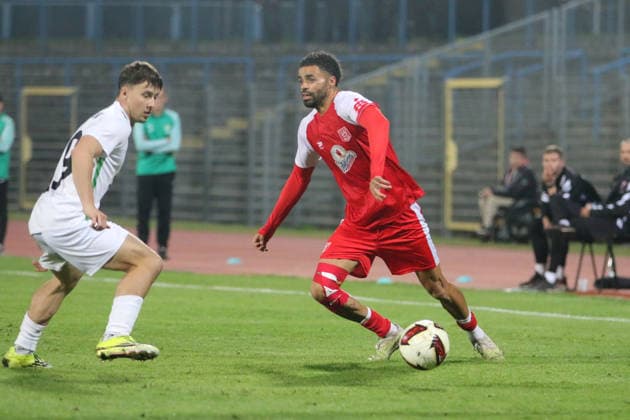 October 2, 2026 Men s Soccer 2026–2027 dachbleche24 State Cup, 2nd Round: SG Reppichau vs. Hallescher FC at Paul Greifzu Stadium in Dessau-Roßlau; Stanley Ratifo (Halle), 30, in red, scores against Louis Lange (Reppichau), 19, in white, misses the goal Dessau-Roßlau Saxony-Anhalt Germany