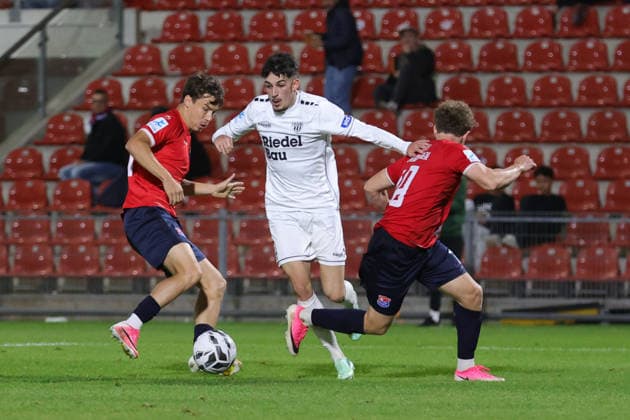 October 2, 2026, Soccer, Men s, Bavarian Regional League, 2026–2027 Season, Matchday 12: SpVgg Unterhaching vs. FC Schweinfurt 05. From left: Jakob Schmid (SpVgg Unterhaching, No. 15) against Leonard Krasniqi (FC Schweinfurt 05, No. 29) and Dominik Lindermeir (SpVgg Unterhaching, 18, Unterhaching, Uhlsport Park, Unterhaching, Bavaria, Germany