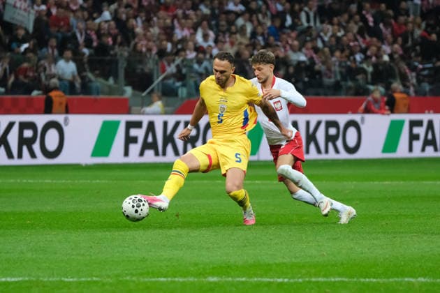 October 2, 2026, Warsaw, Masovian Voivodeship, Poland: Romania s VIRGIL GHITA (5) in action against Poland s SEBASTIAN SZYMANSKI (20) during a UEFA Nations League Group B4 match between the Polish and Romanian national teams at the PGE Narodowy Stadium in Warsaw. Poland went on to win against Romania 6 goals to 0. Soccer 2026: UEFA Nations League: Poland 6:0 Romania  - ZUMAk204 20261002_zip_k204_028 Copyright: xRomanxKozielx