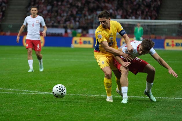 October 2, 2026, Warsaw, Masovian Voivodeship, Poland: Romania s RAZVAN MARIN (18) and Poland s MARCEL REGULA (18) in action during a UEFA Nations League Group B4 match between the Polish and Romanian national teams at the PGE Narodowy Stadium in Warsaw. Poland went on to win against Romania 6 goals to 0. Soccer 2026: UEFA Nations League: Poland 6:0 Romania  - ZUMAk204 20261002_zip_k204_052 Copyright: xRomanxKozielx