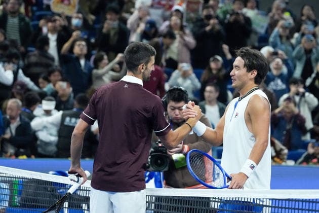 (261003) -- BEIJING, Oct. 3, 2026 -- Novak Djokovic (L) greets Bu Yunchaokete after the men s singles second round match between Bu Yunchaokete of China and Novak Djokovic of Serbia at 2026 China Open tennis tournament in Beijing, China, Oct. 2, 2026. ) (SP)CHINA-BEIJING-TENNIS-CHINA OPEN-MEN S SINGLES(CN) JuxHuanzong 