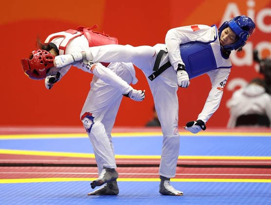 (261003) -- TOYOHASHI, Oct. 3, 2026 -- Zhang Chuling (R) of China competes with Lin Wei-chun of Chinese Taipei during the women -57kg semifinal of taekwondo at the 20th Asian Games Aichi-Nagoya 2026 in Toyohashi of Aichi Prefecture, Japan, Oct. 3, 2026. ) (SP)JAPAN-TOYOHASHI-ASIAN GAMES-TAEKWONDO-WOMEN -57KG WangxFei