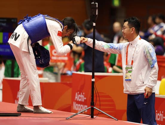 (261003) -- TOYOHASHI, Oct. 3, 2026 -- Zhang Chuling (L) of China celebrates with her coach after match with Lin Wei-chun of Chinese Taipei during the women -57kg semifinal of taekwondo at the 20th Asian Games Aichi-Nagoya 2026 in Toyohashi of Aichi Prefecture, Japan, Oct. 3, 2026. ) (SP)JAPAN-TOYOHASHI-ASIAN GAMES-TAEKWONDO-WOMEN -57KG WangxFei 