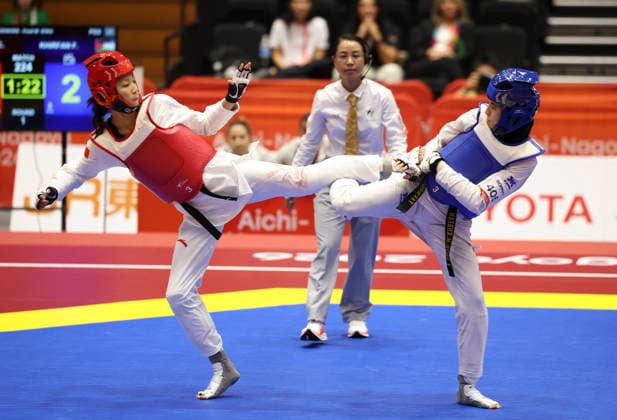 (261003) -- TOYOHASHI, Oct. 3, 2026 -- Zhang Chuling (L) of China competes with Fadia Khirfan of Jordan during the women -57kg gold medal contest of taekwondo at the 20th Asian Games Aichi-Nagoya 2026 in Toyohashi of Aichi Prefecture, Japan, Oct. 3, 2026. ) (SP)JAPAN-TOYOHASHI-ASIAN GAMES-TAEKWONDO-WOMEN S -57KG WangxFei