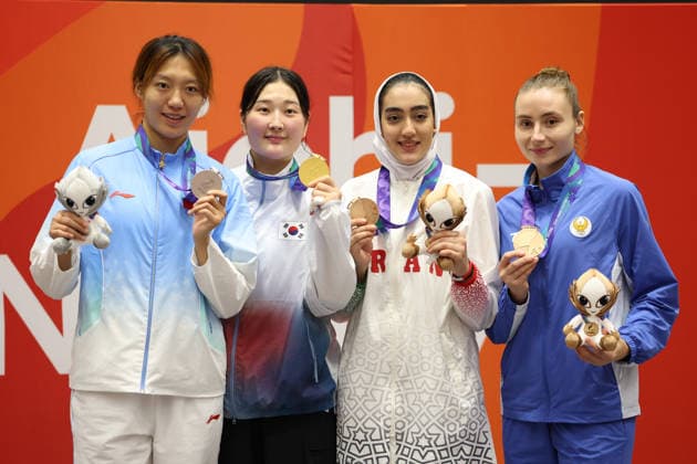 (261003) -- TOYOHASHI, Oct. 3, 2026 -- Gold medalist Song Dabin (2nd L) of South Korea, silver medalist Mu Wenzhe(1st L) of China, bronze medalists Fatameh Ahmadi (2nd R) of Iran and Svetlana Saidova of Uzbekistan pose with their medals during the awarding ceremony for the women s taekwondo +67kg category at the 20th Asian Games Aichi-Nagoya 2026 in Toyohashi of Aichi Prefecture, Japan, Oct. 3, 2026. ) (SP)JAPAN-TOYOHASHI-ASIAN GAMES-TAEKWONDO-WOMEN S +67KG WangxFei 