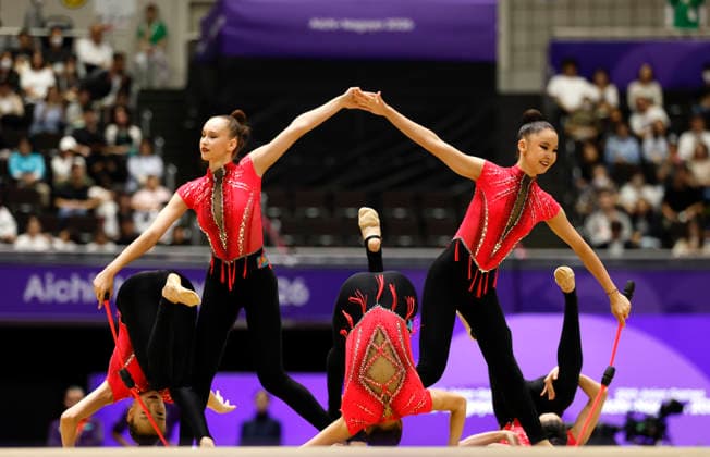 (261003) -- NAGOYA, Oct. 3, 2026 -- Players of team Kazakhstan compete during the 3 Hoops and 2 Clubs of the Group All-Around of Rhythmic gymnastics, Rhythmische Sportgymnastik, RSG at 20th Asian Games Aichi-Nagoya 2026 in Nagoya, Japan, Oct. 3, 2026. ) (SP)JAPAN-NAGOYA-ASIAN GAMES-RHYTHMIC GYMNASTICS-GROUP ALL-AROUND-FINAL WuxZhizun 