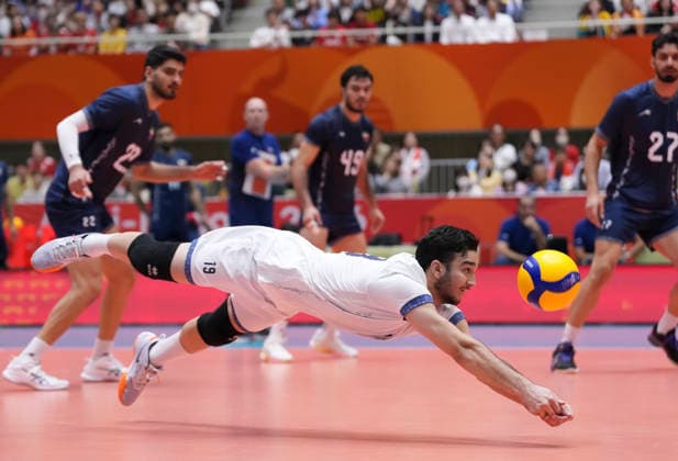 (261003) -- OKAZAKI, Oct. 3, 2026 -- Hossein Haji Kalateh (front) of Iran saves the ball during the men s volleyball final match between Japan and Iran at the 20th Asian Games Aichi-Nagoya 2026 in Okazaki of Aichi Prefecture, Japan, Oct. 3, 2026. ) (SP)JAPAN-OKAZAKI-ASIAN GAMES-VOLLEYBALL-MEN S FINAL-JPN VS IRI JiaxYuchen 