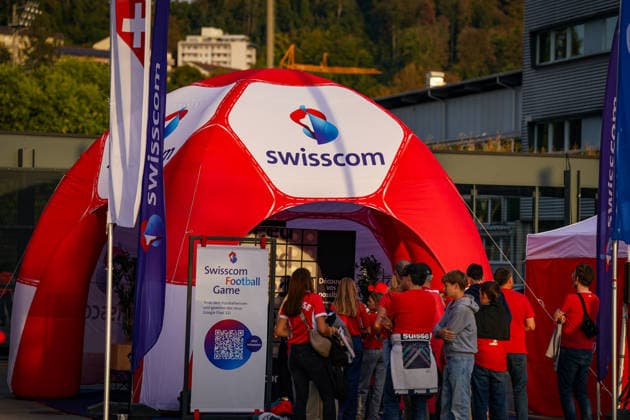 Soccer: UEFA Nations League 2026–2027, Matchday 3: Switzerland vs. Slovenia at Swissporarena Lucerne. Fans visit a Swisscom promotional booth outside the Swissporarena in Lucerne ahead of the international match between Switzerland and Slovenia. A large inflatable soccer ball and flags feature the Swisscom logo, and a Swisscom Football Game is being offered. Swisscom, sponsor, sponsorship, advertising, promotional materials, promotion, fan zone, soccer game, telecommunications, business, fans, spectators, Switzerland, Slovenia, soccer, international match, Swissporarena, Lucerne Copyright: xJOERANxSTEINSIEKx