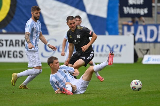 Mirko PUSCHER in action, tackling Emre ERDOGAN 1860 Munich Li Eric UHLMANN 1860 Munich Soccer Bavarian Regional League 2026–2027 season,Matchday 26–27, 12: TSV 1860 Munich vs. SpVgg Ansbach 4–0 on October 3, 2026, at Grünwalder Stadion in Munich