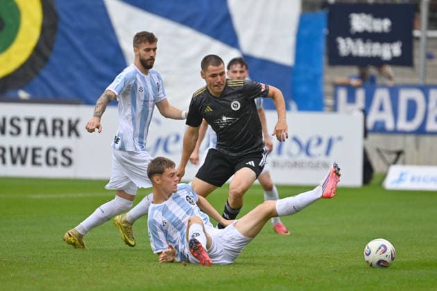 Mirko PUSCHER in action, tackling Emre ERDOGAN, 1860 Munich vs. Eric UHLMANN, 1860 Munich, Bavarian Regional League, 2026–2027 season,Matchday 26–27, December 12: TSV 1860 Munich vs. SpVgg Ansbach 4–0 on October 3, 2026, at Grünwalder Stadion in Munich