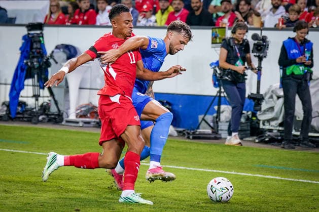 Soccer: UEFA Nations League 2026–2027, Matchday 3: Switzerland vs. Slovenia at Thermoplan Arena Lucerne—Dan Ndoye (Switzerland, No. 11) and David Brekalo (Slovenia, No. 23) in a tackle Copyright: xJOERANxSTEINSIEKx