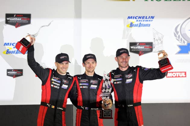 Laurens Vanthoor (BEL), Matt Campbell (AUS), Kevin Estre (FRA) in the No. 6 Porsche 963 on the podium with trophies, awards ceremony, IMSA racing series, 29th Motul Petit Le Mans race, Road Atlanta, Georgia, USA, October 3, 2026, 10-hour race