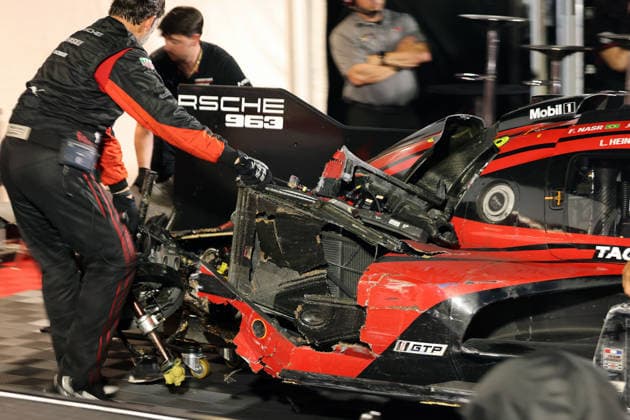 Mechanics pull the Porsche 963 No. 7 driven by Felipe Nasr, Laurin Heinrich, and Julien Andlauer—which was severely damaged in an accident—into the Porsche Penske tent, IMSA racing series, 29th Motul Petit Le Mans race, Road Atlanta, Georgia, USA, October 3, 2026, Retired, Rear section