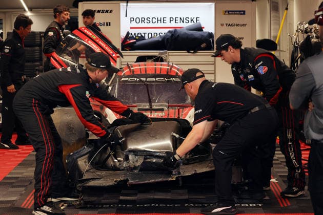 Mechanics are working on the Porsche 963 No. 7, which was severely damaged in an accident; Felipe Nasr, Laurin Heinrich, Julien Andlauer; Porsche Penske tent; IMSA racing series; 29th Motul Petit Le Mans race; Road Atlanta, Georgia, USA; October 3, 2026, Retired,