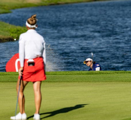 October 3, 2026, Honolulu, Hawaii, USA: PORNANGON PHATLUM, right, makes a chip shot from the bunker at the 18th green while JESSICA PORVASNIK, left, looks on at the 2026 Lotte Championship at Hoakalei Country Club, Ewa Beach, Hawaii, USA. Honolulu USA - ZUMAm310 20261003_zsp_m310_052 Copyright: xElliotxMilesx