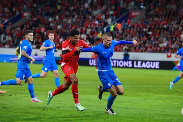 LUCERNE, SWITZERLAND - OCTOBER 03: Zachary Athekame (16 Switzerland, l.) and David Zec (17 Slovenia) during the UEFA Nations League match between Switzerland and Slovenia at thermoplan arena on October 3, 2026 in Lucerne, Switzerland. Copyright: xUrsxOttigerx xSPPx Sportspressphoto_SPR245289