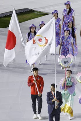 Aichi-Nagoya Asian Games: Closing ceremony Japanese swimmer Shin Ohashi (L) carries the Japanese flag during the closing ceremony of the Aichi-Nagoya Asian Games at Mizuho Park Athletic Stadium in Nagoya, central Japan, on Oct. 4, 2026. A14AA0005630000P