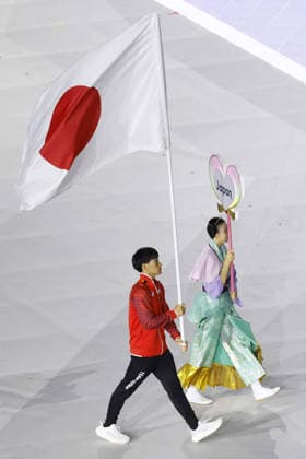 Aichi-Nagoya Asian Games: Closing ceremony Japanese swimmer Shin Ohashi carries the Japanese flag during the closing ceremony of the Aichi-Nagoya Asian Games at Mizuho Park Athletic Stadium in Nagoya, central Japan, on Oct. 4, 2026. A14AA0005630001P