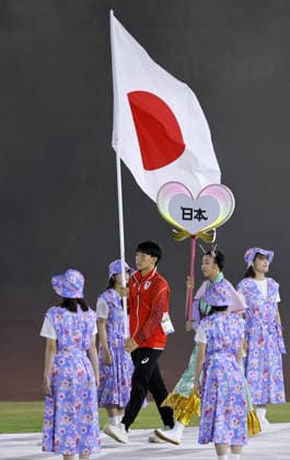 Aichi-Nagoya Asian Games: Closing ceremony Japanese swimmer Shin Ohashi carries the Japanese flag during the closing ceremony of the Aichi-Nagoya Asian Games at Mizuho Park Athletic Stadium in Nagoya, central Japan, on Oct. 4, 2026. A14AA0005630002P