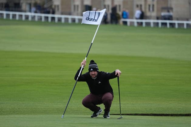 RECORD DATE NOT STATED 4th October 2026; Old Course at St Andrews, St Andrews, Scotland; DP World Tour Golf, Alfred Dunhill Links Championship, Final Day; Connor Syme holds the flag as he lines up his putt on the 1st hole AlecxBrown