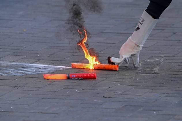 Pyrotechnics: A flare is picked up with a protective glove in Hamburg, Germany, at the Volksparkstadion; soccer; Bundesliga 1; exhibition match; Hamburger SV vs. FC Copenhagen