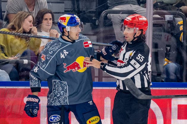 Lucas Thaler of EHC Red Bull Munich, No. 48, is pushed toward the penalty box by linesman Marcus Hoefer. GER, EHC Red Bull Munich vs. Augsburger Panther, DEL, 2026–2027 season, Matchday 6, October 4, 2026. Photo: HMB Media, Heike Feiner Copyright: HMBxMedia HeikexFeiner
