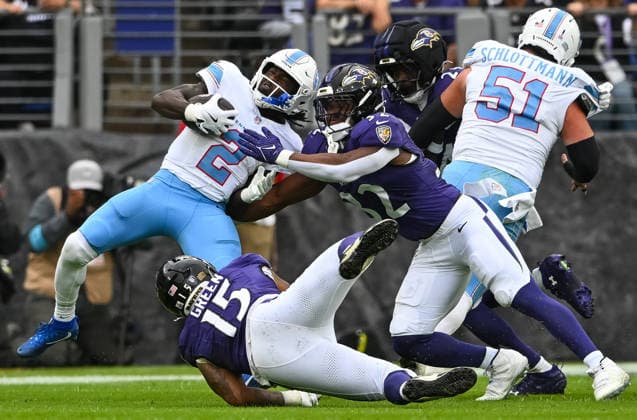 Tennessee Titans running back Tyjae Spears (2) is tackled by Baltimore Ravens linebackers Trenton Simpson (32) and Mike Green (15) during the first quarter at M&T Bank Stadium in Baltimore, Maryland, on Sunday, October 4, 2026.  BAL20261004113 DAVIDxTULIS