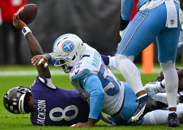 Tennessee Titans defensive end Jacob Martin (57) sacks Baltimore Ravens quarterback Lamar Jackson (8) for a third down loss during the first quarter at M&T Bank Stadium in Baltimore, Maryland, on Sunday, October 4, 2026.  BAL20261004114 DAVIDxTULIS