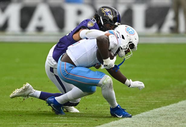 Baltimore Ravens safety Kyle Hamilton (14) tackles Tennessee Titans running back Tyjae Spears (2) after a pitch out on third down during the second quarter at M&T Bank Stadium in Baltimore, Maryland, on Sunday, October 4, 2026.  BAL20261004106 DAVIDxTULIS