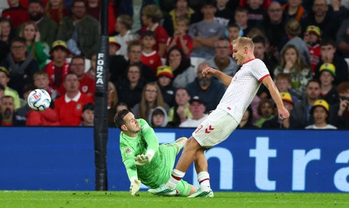 Danny Ward of Wales fouls Gustav Isaksen of Denmark for a penalty Wales v Denmark, UEFA Nations League, Football, Cardiff City Stadium, Cardiff, UK - 04 Oct 2026Cardiff Cardiff City Stadium United Kingdom  Copyright: xKieranxMcManus Shutterstockx 17185536ah