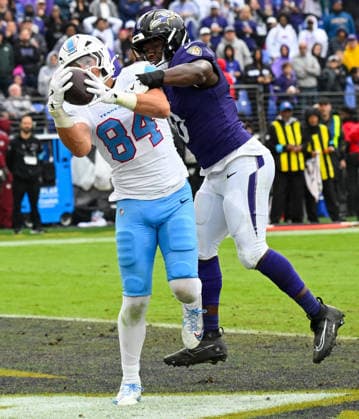 Tennessee Titans tight end Gunnar Helm (84) brings down a pass in the end zone for a two pint conversion ahead of Baltimore Ravens inside linebacker Roquan Smith (0) during the fourth quarter at M&T Bank Stadium in Baltimore, Maryland, on Sunday, October 4, 2026. Baltimore won 24-18.  BAL20261004116 DAVIDxTULIS