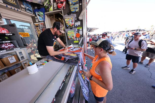 LAS VEGAS, NV - OCTOBER 04: Chase Briscoe ( 19 Joe Gibbs Racing Bass Pro Shops Toyota) signs a flag for a fan in the Joe Gibbs Racing Merchandise Trailer during a meet and greet before the NASCAR, Motorsport, USA Cup Series Playoffs South Point 400 on October 4, 2026, at Las Vegas Motor Speedway in Las Vegas, NV. (Photo by Marc Sanchez Icon Sportswire) AUTO: OCT 04 NASCAR Cup Series Playoffs South Point 400 EDITORIAL USE ONLY Icon14426100401074