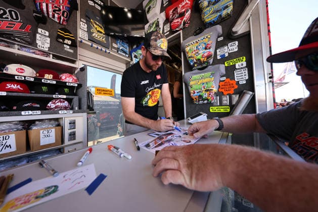 LAS VEGAS, NV - OCTOBER 04: Chase Briscoe ( 19 Joe Gibbs Racing Bass Pro Shops Toyota) signs a hero card for a fan in the Joe Gibbs Racing Merchandise Trailer during a meet and greet before the NASCAR, Motorsport, USA Cup Series Playoffs South Point 400 on October 4, 2026, at Las Vegas Motor Speedway in Las Vegas, NV. (Photo by Marc Sanchez Icon Sportswire) AUTO: OCT 04 NASCAR Cup Series Playoffs South Point 400 EDITORIAL USE ONLY Icon14426100401098
