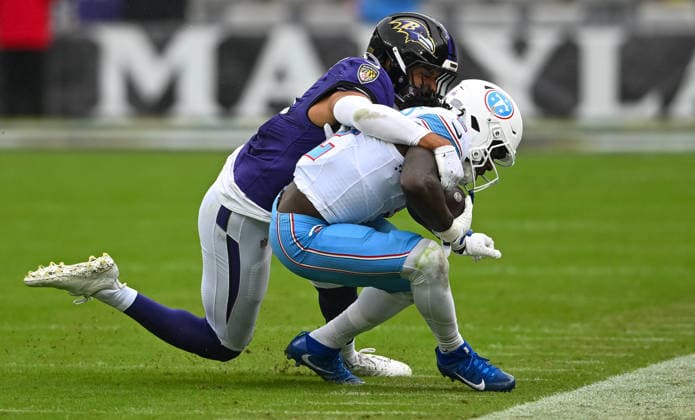 Baltimore Ravens safety Kyle Hamilton (14) tackles Tennessee Titans running back Tyjae Spears (2) after a pitch out on third down during the second quarter at M&T Bank Stadium in Baltimore, Maryland, on Sunday, October 4, 2026.  BAL20261004134 DAVIDxTULIS