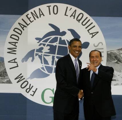 Italian Prime Minister Silvio Berlusconi (R) greets U.S. President Barack Obama as he arrives for a round table session at the G8 summit in L Aquila, Italy on July 8, 2009. (UPI Photo Stringer)  LAQ2009070841