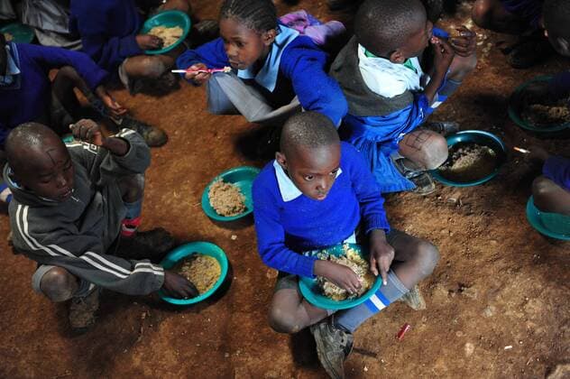 (110626) -- NAIROBI, June 26, 2011(Xinhua) -- Students of MCEDO-Beijing School eat their free lunch on the ground of the classroom in Mathare slum of Nairobi, Kenya, June 24, 2011. MCEDO-Beijing School provides free lunch for all the 600 students. The school feeding program was initiated by UN World Food Program (WFP) to supply one hot nutritious meal a day to school children in Kenya. For some of the poor children, this school meal is the only meal that they will eat in a day. (Xinhua Zhao Yingquan) (djj) KENYA-NAIROBI-MATHARE-POVERTY-FREE LUNCH 