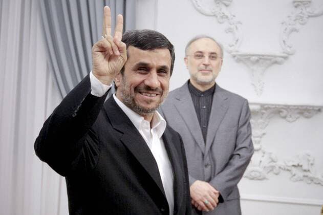 Iranian President Mahmoud Ahmadinejad shows victory sign prior his official meeting with Turkish Foreign Minister Ahmet Davutoglu (unseen) in the Presidential palace in Tehran,Iran on January 5, 2012.  IRN2012010501