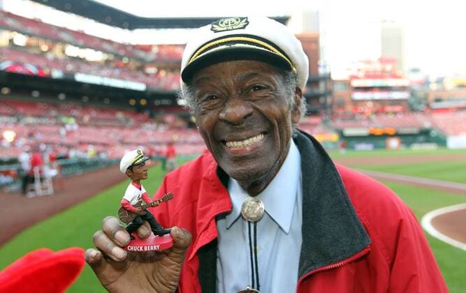 Legendary Rock n Roll guitarist Chuck Berry holds his bobblehead before a ceremonial first pitch during the Arizona Diamondbacks - St. Louis Cardinals baseball game at Busch Stadium in St. Louis on May 21, 2014.  SLP2014052101