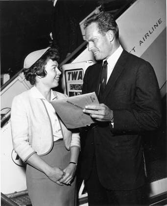 Oct. 6, 1961 - New York, NY, U.S. - Actor CHARLTON HESTON known for his religious roles in Ben-Hur and The Ten Commandments , with TWA hostess PAT SELZ as he arrived in New York. New York United States of America  - ZUMAk09