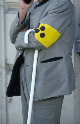 Mann mit Blindenstock und Blindenbinde man with white cane and identification armband for the visually impaired BLWS199304