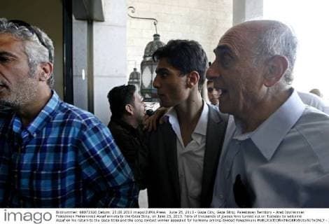 June 25, 2013 - Gaza City, Gaza Strip, Palestinian Territory - Arab Idol winner Palestinian Mohammed Assaf arrives to the Gaza Strip, on June 25, 2013. Tens of thousands of joyous fans turned out on Tuesday to welcome Assaf on his return to the Gaza Strip and the song contest winner appealed for harmony among divided Palestinians  - ZUMAews