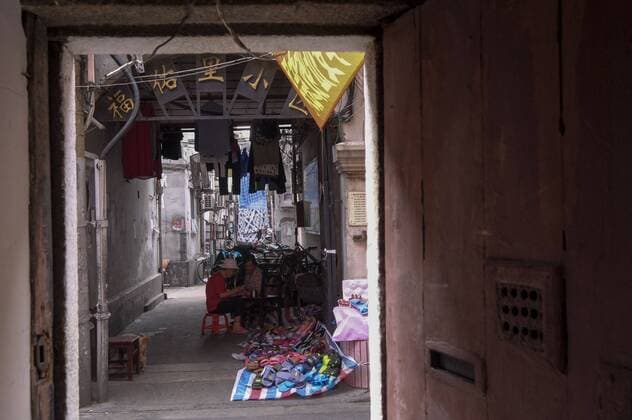 September 7, 2016 - Los Angeles, California, U.S - Street hawker sells sandals at the old residential district near Yu Garden in Shanghai, China. Shanghai is the most populous city in China and the most populous city proper in the world. It is one of the four direct-controlled municipalities of China, with a population of more than 24 million as of 2014. It is a global financial centre, and a transport hub with the world s busiest container port. Located in the Yangtze River Delta in East China, Shanghai sits on the south edge of the mouth of the Yangtze in the middle portion of the Chinese coast. The municipality borders the provinces of Jiangsu and Zhejiang to the north, south and west, and is bounded to the east by the East China Sea. A major administrative, shipping, and trading town, Shanghai grew in importance in the 19th century due to trade and recognition of its favourable port - ZUMAc68_