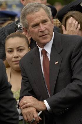 May 15, 2005; Washington, DC, United States; President GEORGE W BUSH stops to pose for a picture next to an unidentified woman on the west front lawn of the US Capitol May 15, 2005 Washington, DC. The President had just delivered the keynote address to police officers, families, and survivors of those officers who had lost their lives in the line of duty, during the 24th Annual National Peace Officers Memorial Service. President Bush acknowledged the sacrifice time and again during his address, saying Our nation stands in admiration and gratitude for their service, and we ask God s blessings for the families and friends they have left behind. The President spent well over an hour and a half greeting survivors, listening to stories, posing for pictures and signing the memorial programs waved in front of him.. - ZUMAg44_ 20050515_kri_g44_005 Copyright: xChrisxGreenbergx