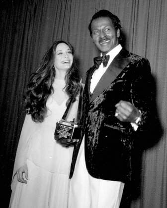 CHUCK BERRY (October 18, 1926 - March 18, 2017) was an American guitarist, singer and songwriter and is one of the pioneers of rock and roll music. With iconic songs such as Maybellene (1955), Roll Over Beethoven (1956), Rock and Roll Music (1957) and Johnny B. Goode (1958), Berry refined and developed rhythm and blues into the major elements that made rock and roll distinctive, with lyrics focusing on teen life and consumerism and music featuring guitar solos and showmanship that were a major influence on subsequent rock music. PICTURED: CHUCK BERRY and MARY CROSBY circa 1970 s.  - ZUMA 20050114_mda_g49_159 Copyright: xGlobexPhotosx