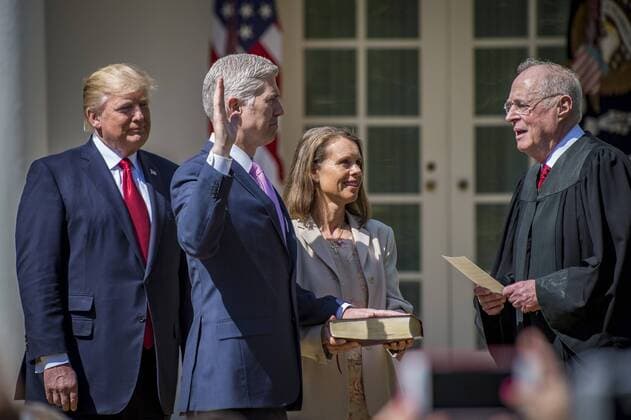 President Donald Trump looks on as Supreme Court Justice Anthony Kennedy administers the judicial oath to Neil Gorsuch to be a Supreme Court Associate Justice as his wife, Marie Louise, holds the bible in the Rose Garden at the White House on April 10, 2017 in Washington, DC. Gorsuch was sworn in earlier in the morning at the U.S. Supreme Court by Chief Justice John Roberts. Gorsuch is the 113th justice in the history of the Supreme Court. WAP201704100245 PETExMAROVICH