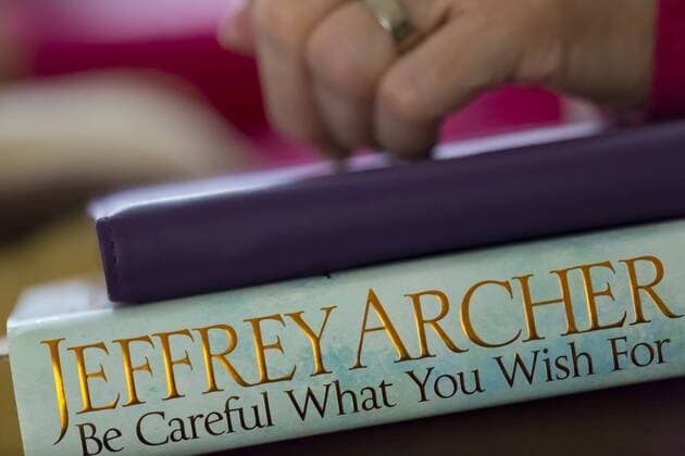 A woman s hand on an iPad and book. Copyright: xBillxAllsopp LOOPxIMAGESx BAL0511559
