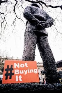 September 1, 2013 - London, United Kingdom - A poster seen lying down nearby a statue during the march..Scores of women across the United Kingdom took to the streets on Sunday to protest sexual harassment and assault, marking the anniversary of Donald Trump™s first full day as U.S. president. Braving the rain, demonstrators gathered opposite Downing Street in London, chanting times up, in support of a namesake campaign launched by American and British women in the entertainment industry advocating for women™s rights. Gender-based violence has recently captured public imagination as a result of Trump™s political ascension, as well as the expose of powerful men who have endorsed and imbibed misogynistic, discriminatory as well as sexually violent policies across industry. London United Kingdom - ZUMAs197 20130901_zaa_s197_011 Copyright: xDanielxStephenxHomerx xSopaxImagx